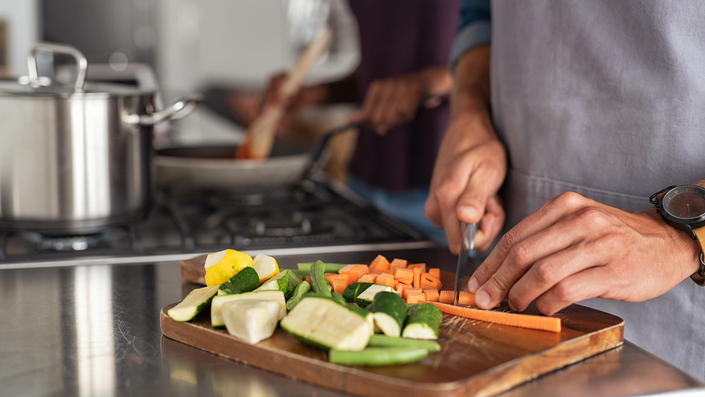 People cooking and cutting vegetables