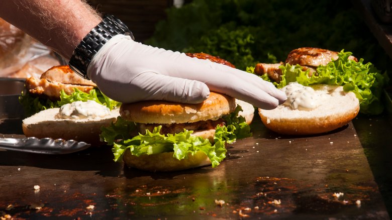 man pressing on burger