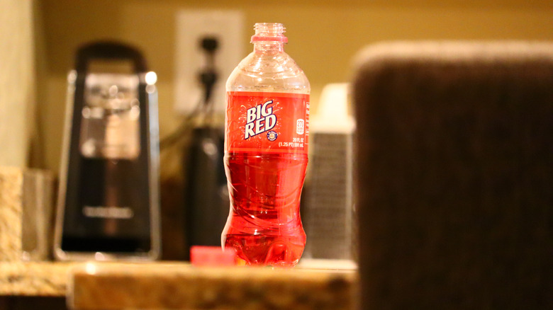 A bottle of Big Red soda on a table