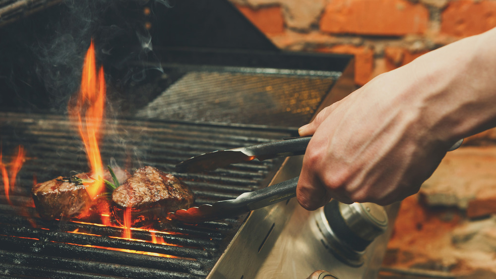 cooking steak on a grill