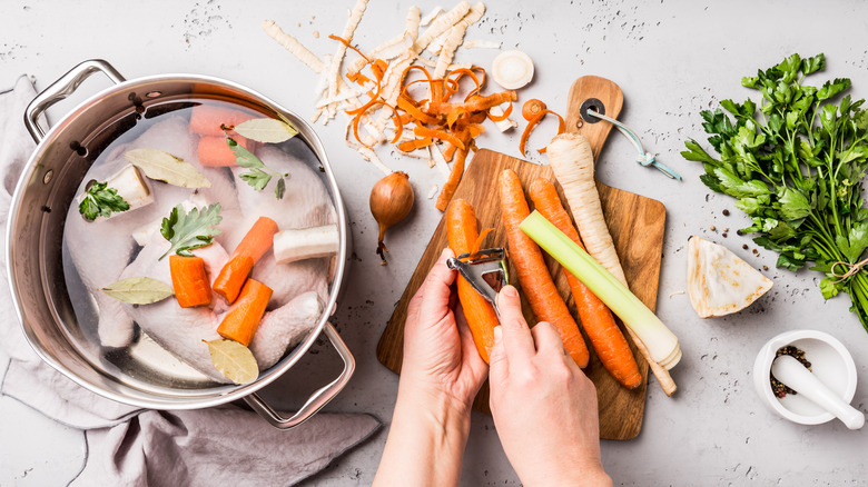 Chef's hands preparing broth