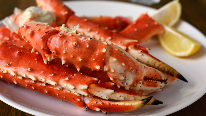 Crab legs on a plate with lemon