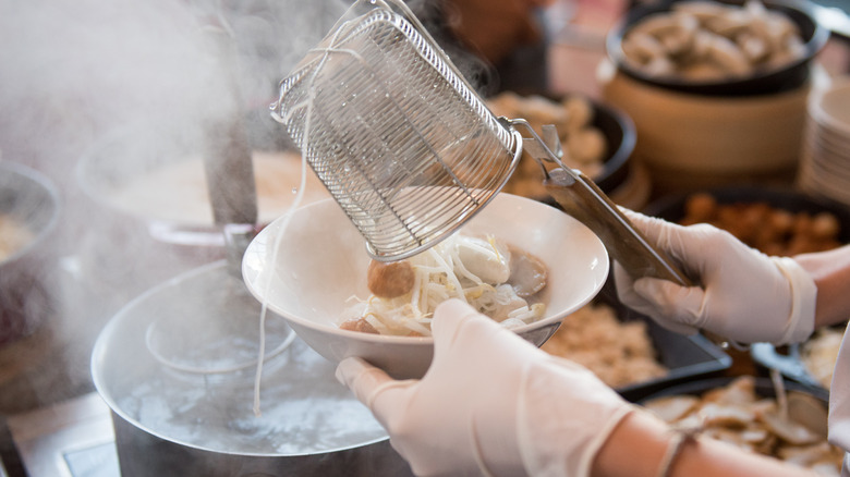 Asian soup with dumplings in boiling stock 