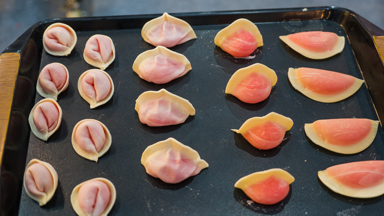 Dumplings on baking sheet and ready for the oven