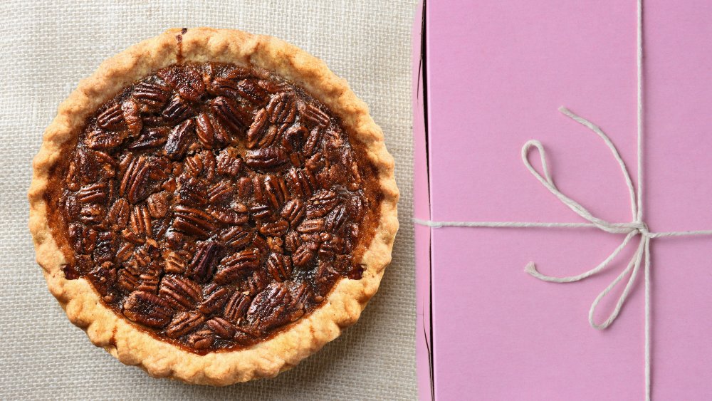 pecan pie next to a pink box