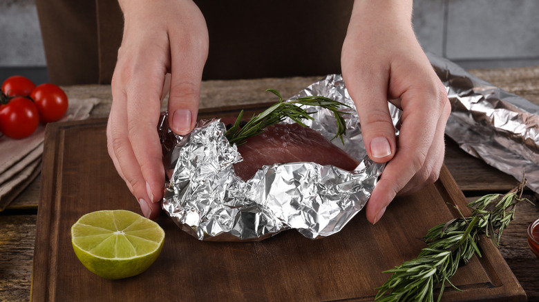 meat being wrapped in foil