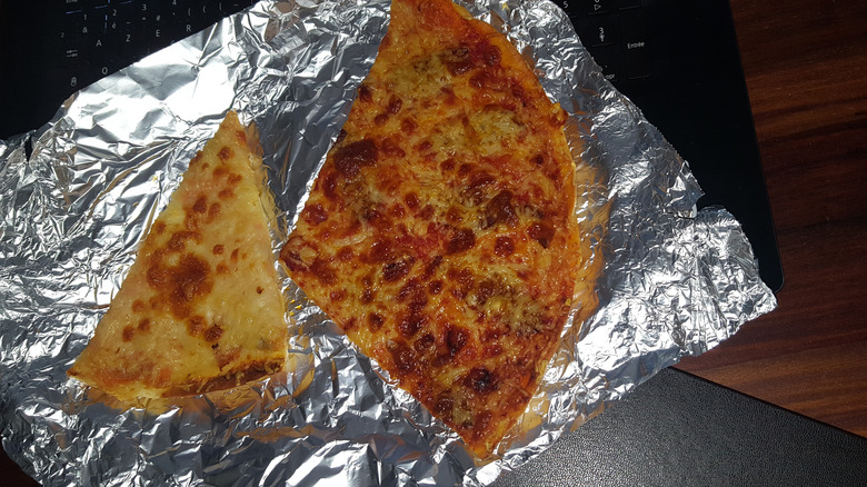 slices of pizza on aluminum foil