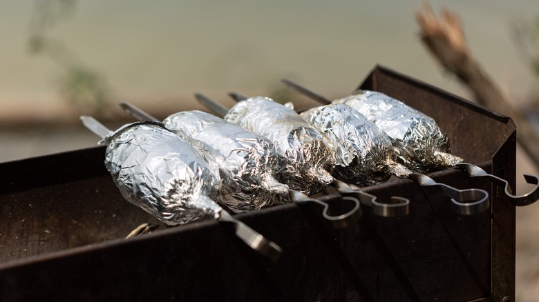 foil-wrapped food on grill