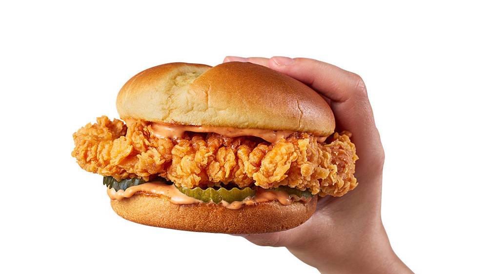 Hand holding Zaxby's Signature Sandwich