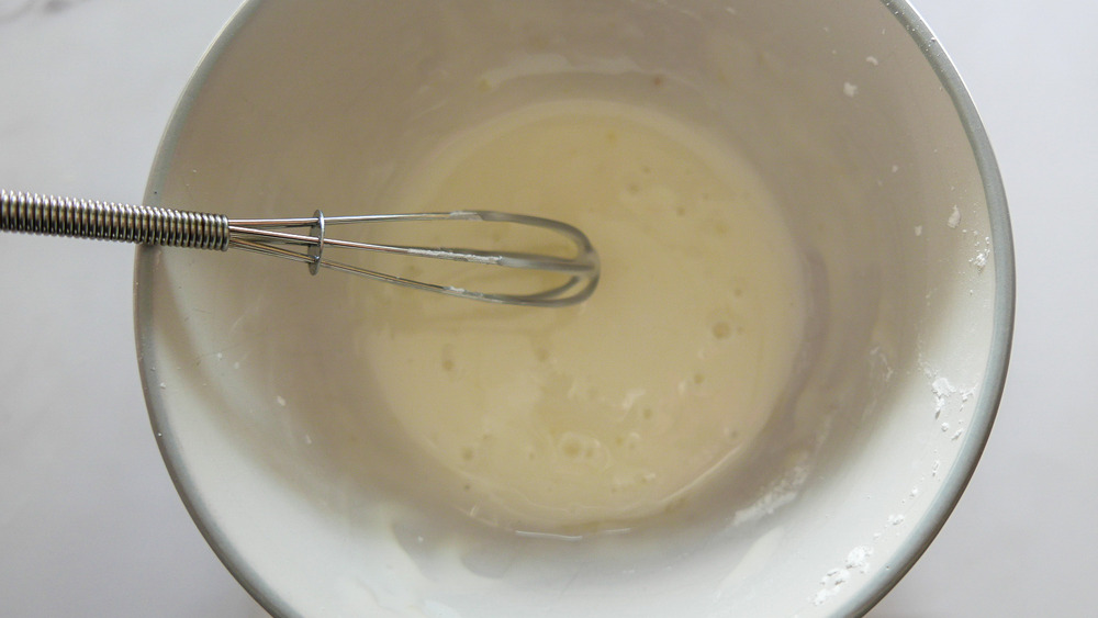 icing in bowl with whisk