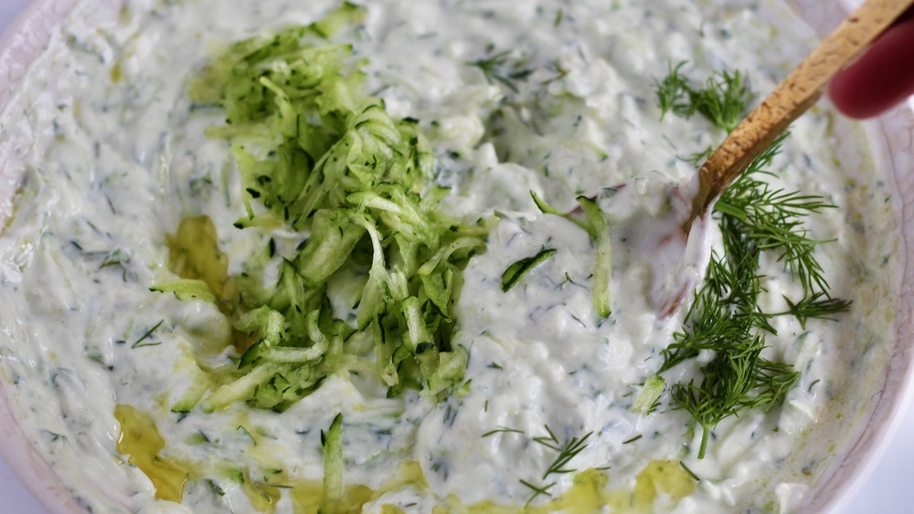 Tzatziki ingredients together in a white bowl